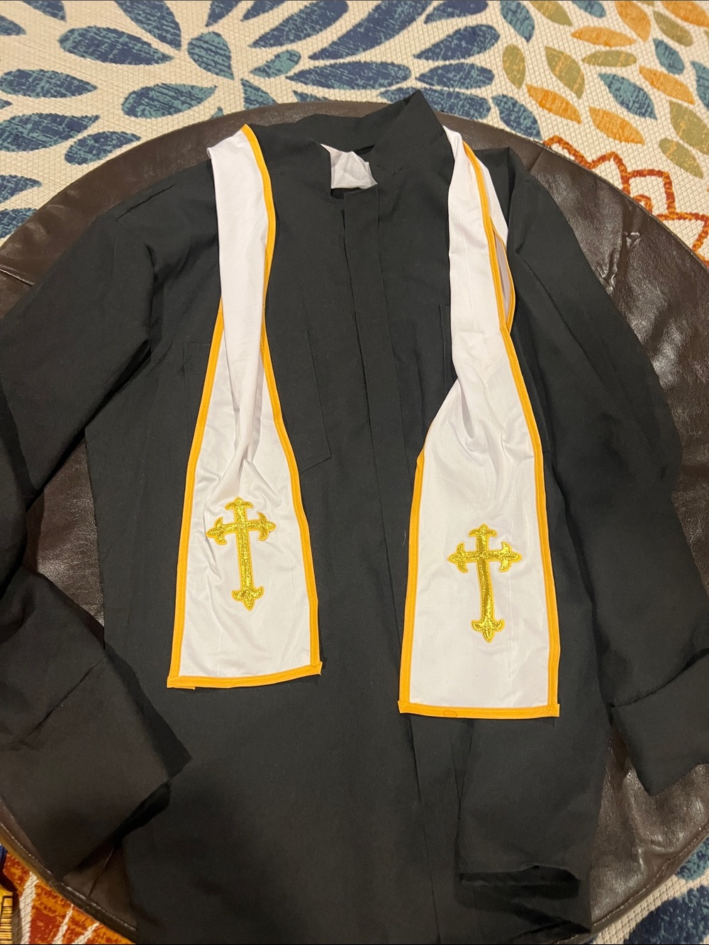 Costume: Men's Black Clergy Coat with White & Gold Stole.